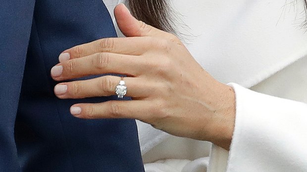 Britain's Prince Harry's fiancee Meghan Markle shows off her engagement ring.