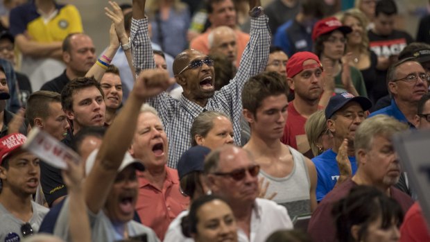 Attendees cheer as Donald Trump speaks during a campaign event in Phoenix, Arizona.