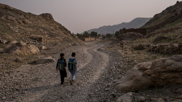 Bilal, left, and his relative Yasir with their backpacks in Nangarhar.