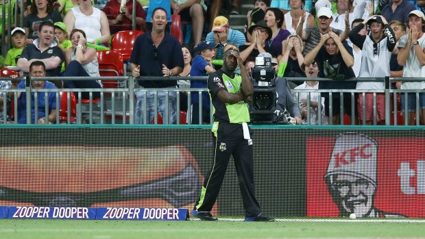 Night to forget: Andre Russell reacts after the dropped catch he deflected over the rope for six.