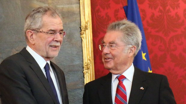 Austrian President Heinz Fischer, right, welcomes Alexander Van der Bellen, left, winner of Austria's presidential election at the Hofburg palace in Vienna on Tuesday. 