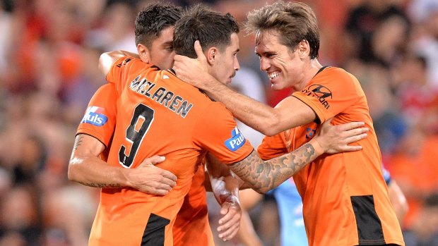 That'll do: Jamie Maclaren of the Roar celebrates with his teammates after scoring.