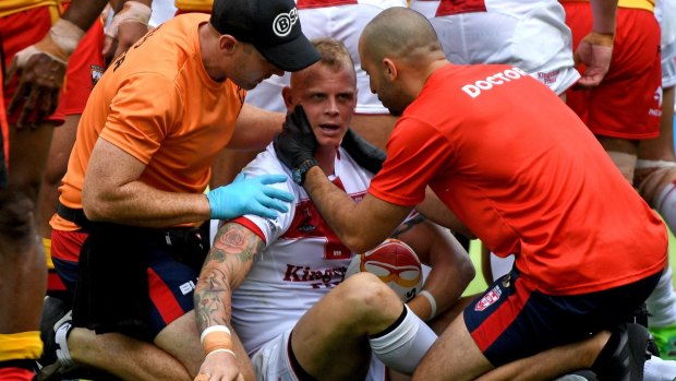 History of head knocks: Kevin Brown is treated by team medics after a heavy tackle against Papua New Guinea.