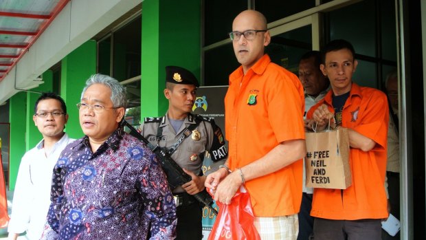Neil Bantleman and Ferdinant Tjiong leaving the police station to be transferred to prison in November 2014.