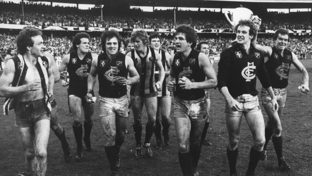 Jubilant Carlton players run a lap of honour after winning the 1979 grand final against Collingwood.