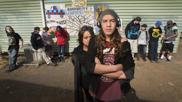 Daniel Hamilton, 18, with his mother, Charmaine, and students at the CALM school, which helps struggling youngsters.