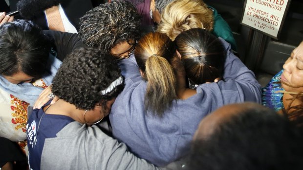 Supporters of the victims pray after the verdicts.