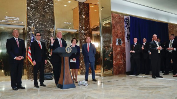 President Donald Trump speaks to the media in the lobby of Trump Tower.