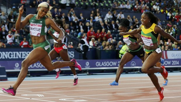 Blessing Okagbare (L) of Nigeria finishes first ahead of Veronica Campbell-Brown of Jamaica.