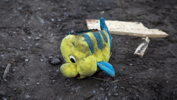 A child's toy lies discarded on the ground as demolition teams remove migrants' tents in the 'Jungle' camp.