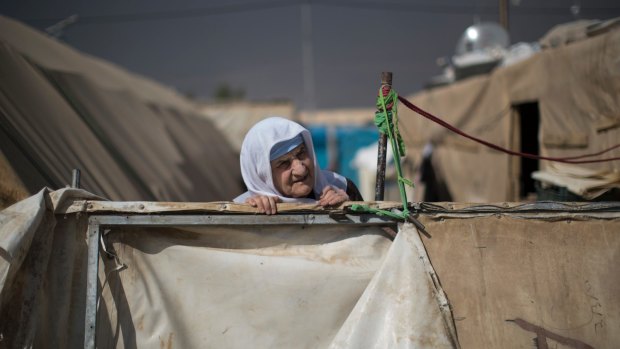 An elderly woman looks out from her home in the Yahyawa camp for internally displaced Turkmen on the outskirts of Kirkuk, Iraq. Over 600 families from Tel Afar, west of Mosul, are hoping for their town to be liberated from Islamic State militants so they can return to their homes.
