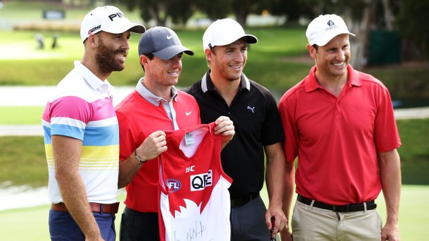 On course: Sydney Swans Jarrad McVeigh and Kieren Jack, and former Swan Jude Bolton present Rory McIlroy (second from left) with a Swans jumper on Wednesday.