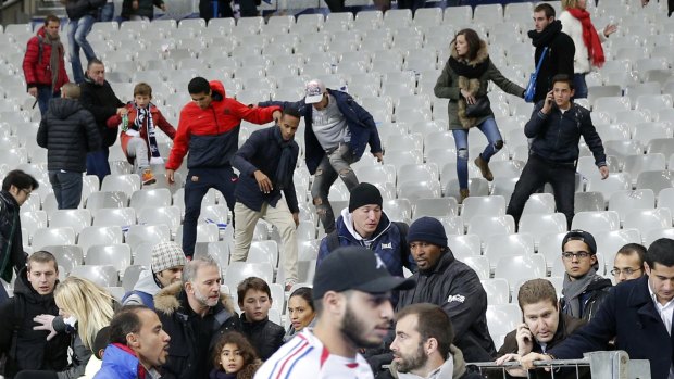 Soccer fans move towads the grounds at the Stade de France after explosions were heard during the friendly match between France and Germany. 