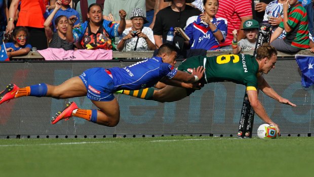 Hands-on: Daly Cherry-Evans scores in the corner for the Kangaroos against Samoa.