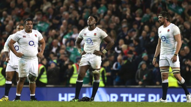 Shocked: England players come to terms with their loss against Ireland.