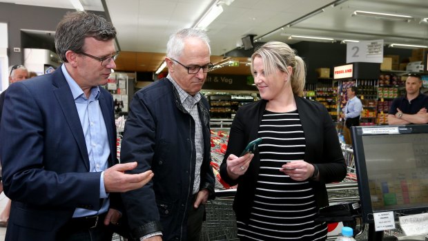 Minister for Human Services Alan Tudge and Prime Minister Malcolm Turnbull are shown the cashless debit card in use.