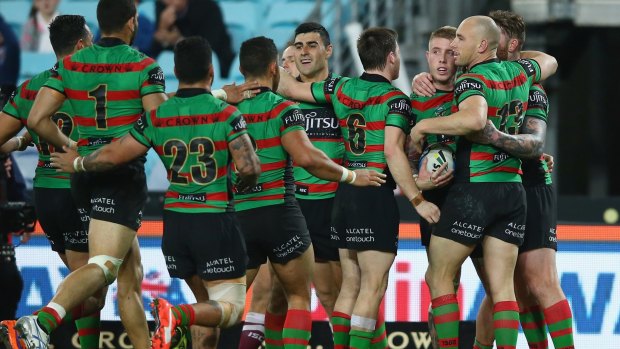 Nice work: Aaron Gray, ball in hand, of the Rabbitohs celebrates with teammates after scoring.