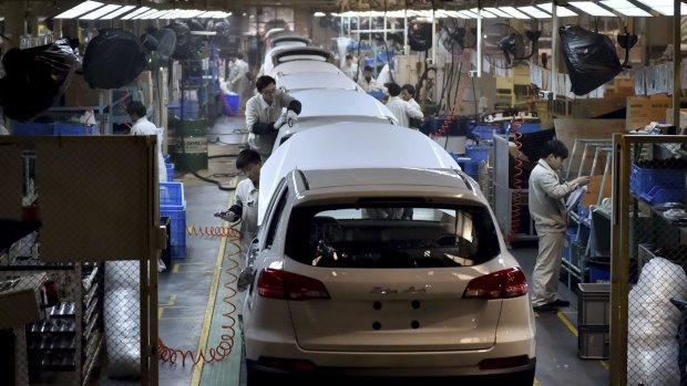 Chinese workers labour on the assembly line of the X5 SUV of Zotye Auto in Hangzhou in east China's Zhejiang province. 