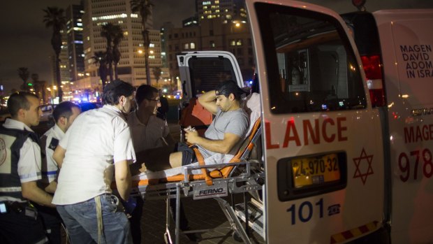 A wounded man is evacuated from the scene of a stabbing attack in Jaffa, a mixed Jewish-Arab part of Tel Aviv, Israel.