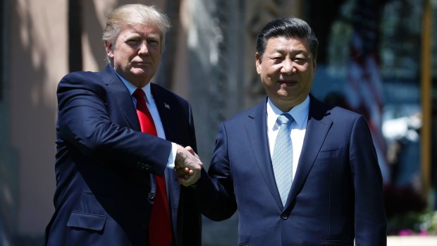 US President Donald Trump and Chinese President Xi Jinping pause for photographs on Friday.