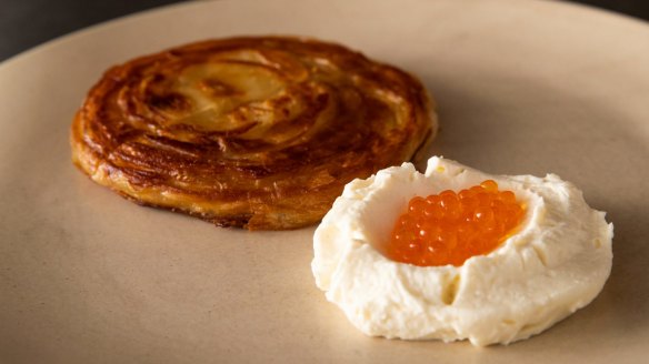 Malawach, a flaky Yemenite pastry, with house-made buttermilk ricotta and trout roe. 