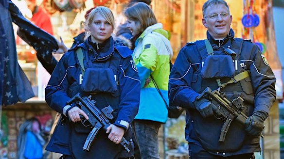 Police officers patrol at the Christmas market in Dortmund, Germany.