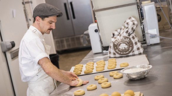 Bagels go through many stages of preparing including mixing, resting, rolling, shaping, boiling and baking.