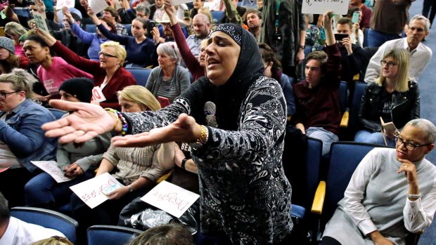 Noor Ul-Hasan reacts during Representative Jason Chaffetz's town hall meeting in Utah. 