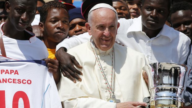 Pope Francis with migrants in St Peter's Square in June 2016.