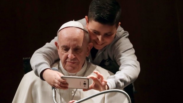Even Pope Francis, it seems, can fall for the allure of a selfie.