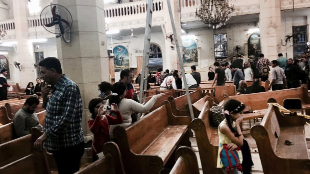 People look at damage inside St George's church after a suicide bombing in the Nile Delta town of Tanta in April.