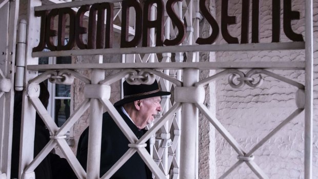 Holocaust survivor Guenter Pappenheim walks through the gates at the old Buchenwald concentration camp near Weimar, Germany to attend a wreath-laying ceremony to mark International Holocaust Remembrance Day on Saturday.