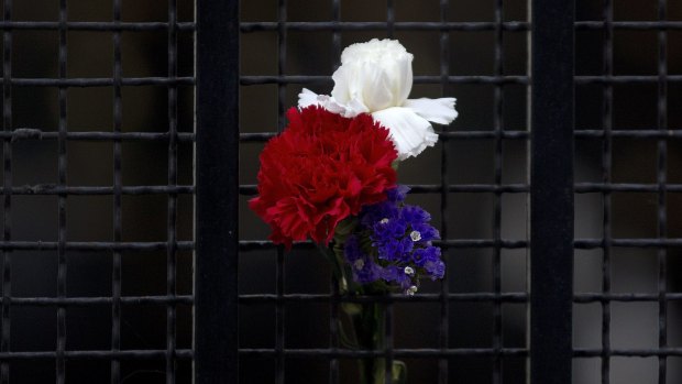Flowers in the colours of the French flag are displayed on the gate of the French Embassy in Madrid, Spain, on Saturday.