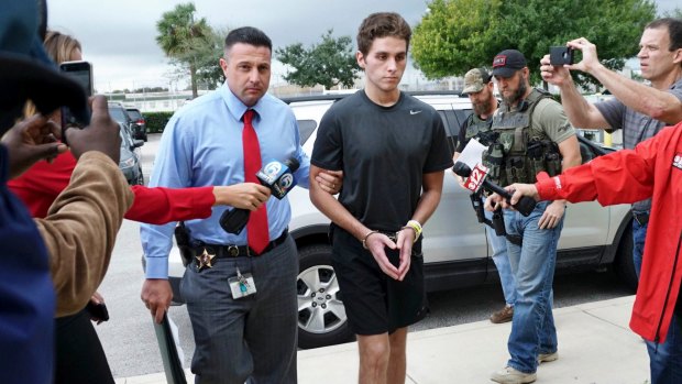 Austin Harrouff is transported by detectives to the Martin County Jail from St. Mary's Hospital in Florida in 2016.
