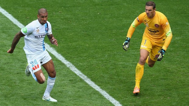 Patrick Kisnorbo of Melbourne City tries to beat Wanderers' goalkeeper Ante Covic to the ball.