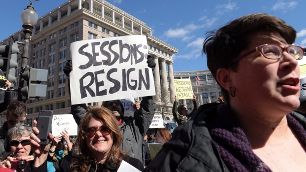 Protesters gather outside the Justice Department in Washington.