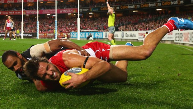 My ball: Josh Kennedy of the Swans is tackled at the SCG.
