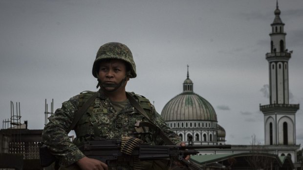 A soldier walking past a mosque in Marawi, southern Philippines. 