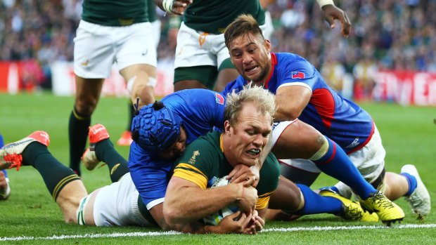 Schalk Burger of South Africa goes over to score his team's third try.