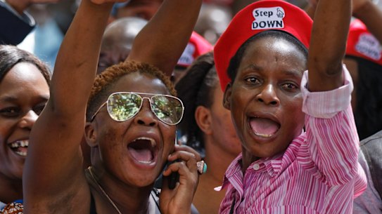 Protesters calling for the impeachment of President Robert Mugabe demonstrate outside the parliament building in downtown Harare, Zimbabwe Tuesday, Nov. 21, 2017. (AP Photo/Ben Curtis)