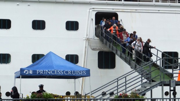 Passengers of the Emerald Princess cruise ship disembark following the incident.