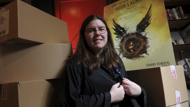 Harry Hartog store team leader Kaitlyn South stands among boxes of <i>Harry Potter and the Cursed Child</i>, with strict instructions not to open them until 9.01am on Sunday.