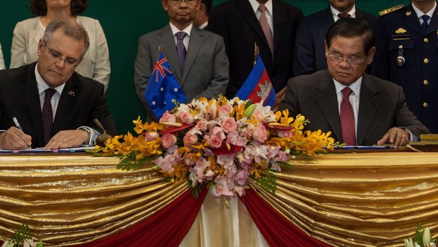 Australia's then immigration minister Scott Morrison and Cambodian Interior Minister Sar Kheng sign an agreement to resettle refugees in Cambodia.