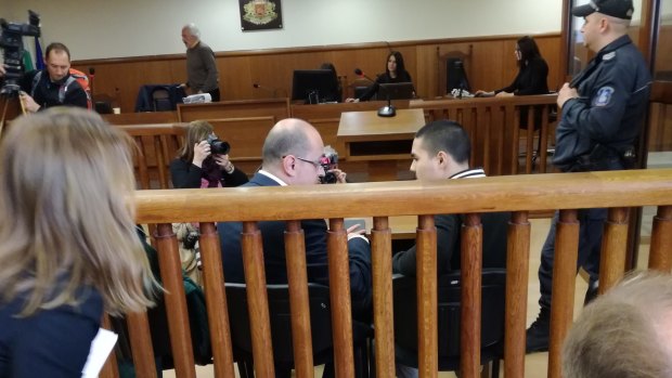 Bulgarian lawyer Histro Botev speaks with his client Australian John Zakhariev, right seated, in court in Sofia on Friday.