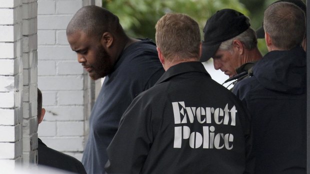Authorities remove David Wright, a relative of Usaama Rahim, from a house in Everett, Massachusetts, after a day-long police investigation at the property. 
