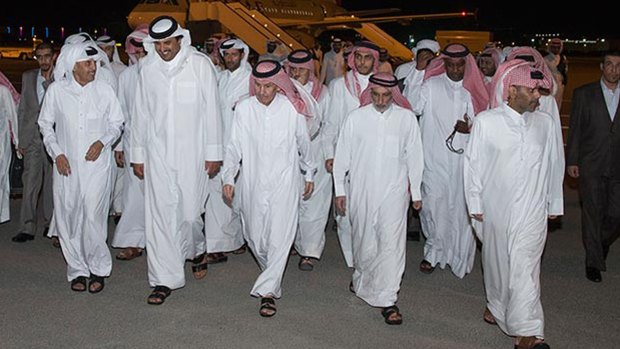 The Emir of Qatar, Sheikh Tamim bin Hamad al-Thani, second left in front row, receives freed Qataris at Doha airport on April 21 after reputedly paying $US1 billion for their release from Iraq.