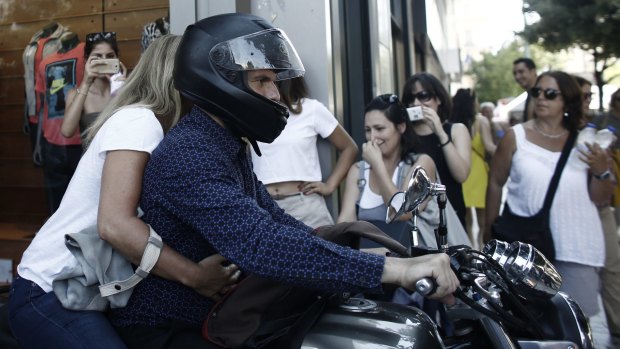 Rockstar: Varoufakis leaves the Greek finance ministry with his wife at the height of the debt crisis. 