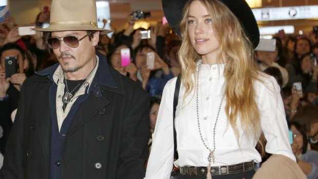 Amber Heard and Johnny Depp, pictured in 2015, will settle their divorce case.