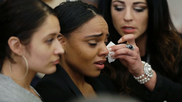 Shayanna Jenkins Hernandez, center, the fiancee of Aaron Hernandez, is comforted as she reacts to Hernandez's double murder acquittal.