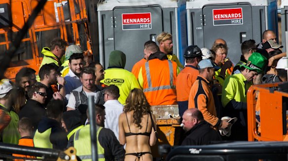 Strippers were seen handing out drinks and mingling with construction workers at the Geocon Wayfarer apartment building site in Belconnen on Friday afternoon.